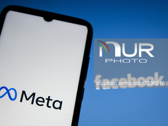 In this photo illustration Meta logo is displayed on smartphone screen and Facebook logo on a computer screen as background in Athens, Greec...