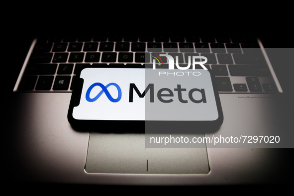Meta logo displayed on a phone screen and a laptop keyboard are seen in this illustration photo taken in Krakow, Poland on October 29, 2021....