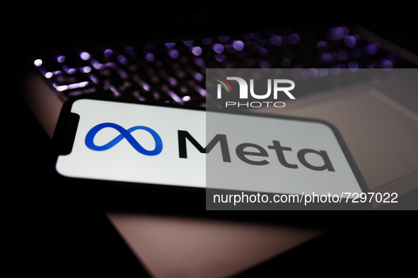 Meta logo displayed on a phone screen and a laptop keyboard are seen in this illustration photo taken in Krakow, Poland on October 29, 2021....