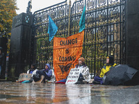 Four activists from Extinction Rebellion Glasgow University lock themselves to the Memorial Gate at the University of Glasgow on October 29,...