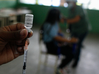 A health worker prepares a dose of the vaccine manufactured in China Sinopharm during an immunization day against Covid-19 at a high school...