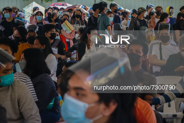 Voter registrants from Antipolo City, Philippines camps outside their designated registration site since last night, October 29, 2021 for th...