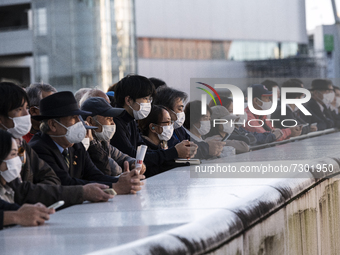 People wearing masks listen to a politician giving a stump speech in Saitama, 29 Oct.
 (