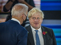 Boris Johnson, right, Prime Minister of the United Kingdom, looks at Joe Biden, left, President of the United States, in the Table of G20 Su...
