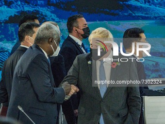 Boris Johnson, right, Prime Minister of the United Kingdom, salutes Moussa Faki, President of The African Union Commission, left, in the Tab...