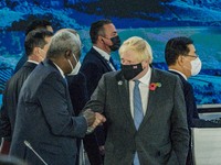 Boris Johnson, right, Prime Minister of the United Kingdom, salutes Moussa Faki, President of The African Union Commission, left, in the Tab...
