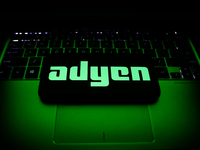 Adyen logo displayed on a phone screen and a laptop keyboard are seen in this illustration photo taken in Krakow, Poland on October 30, 2021...
