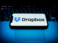 Dropbox logo displayed on a phone screen and a laptop keyboard are seen in this illustration photo taken in Krakow, Poland on October 30, 20...