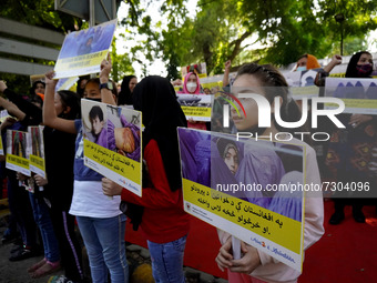 Afghan nationals residing in India hold placards as they participate in a protest demanding better rights for women in Afghanistan, during a...