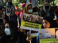 Afghan nationals residing in India hold placards as they participate in a protest demanding better rights for women in Afghanistan, during a...