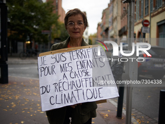 After being put of the road by policemen, a woman shows her placard 'I'm terrified for my children by the global warming'. XR France (Extinc...