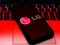 LG logo displayed on a phone screen and a laptop keyboard are seen in this illustration photo taken in Krakow, Poland on October 30, 2021. (