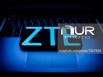 ZTE logo displayed on a phone screen and a laptop keyboard are seen in this illustration photo taken in Krakow, Poland on October 30, 2021....