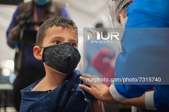 A child receives his first dose of the COVID-19 vaccine as the Colombian government begins to vaccinate children between ages 3 to 11 agains...