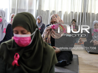 Palestinian cancer patients practise yoga during a therapy session in Gaza city on November 1, 2021. (