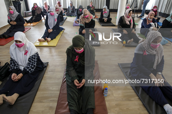 Palestinian cancer patients practise yoga during a therapy session in Gaza city on November 1, 2021. 
