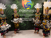 Dancers pose in Indonesian Pavilion at the COP26 UN Climate Change Conference, held by UNFCCC inside the COP26 venue - Scottish Event Campus...