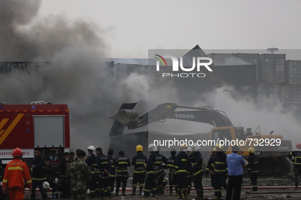 (150814) -- TIANJIN, Aug. 14, 2015 () -- Firefighters put out flames in a container at the site of the explosion in Tianjin, north China, Au...