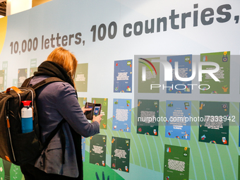 A participant reads letters of actisists during the fifth day of the COP26 UN Climate Change Conference, held by UNFCCC inside the COP26 ven...