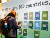 A participant reads letters of actisists during the fifth day of the COP26 UN Climate Change Conference, held by UNFCCC inside the COP26 ven...