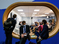Participants sit in EU Pavilion during the fifth day of the COP26 UN Climate Change Conference, held by UNFCCC inside the COP26 venue - Scot...