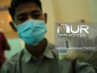 A health worker is seen preparing an injection of the Moderna vaccine against the Corona Covid-19 virus in Lhokseumawe, on November 5, 2021,...