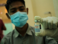 A health worker is seen preparing an injection of the Moderna vaccine against the Corona Covid-19 virus in Lhokseumawe, on November 5, 2021,...