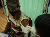 A man is seen receiving an injection of the Moderna vaccine against the Corona Covid-19 virus in Lhokseumawe, On November 5, 2021, Aceh Prov...