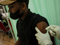 A man is seen receiving an injection of the Moderna vaccine against the Corona Covid-19 virus in Lhokseumawe, On November 5, 2021, Aceh Prov...