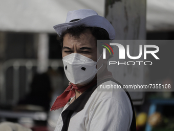 A person dressed as the Mexican comedian Cantinflas in the streets of Mexico City, during the COVID-19 health emergency and the green epidem...
