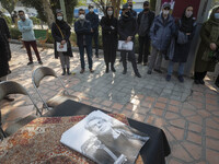 Iranians wearing protective face masks attend a funeral for Iranian cartoonist Kambiz Derambakhsh out of the Iranian Artists Forum in downto...