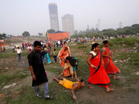 A Hindu devotee offers prayer while laying on the ground as they arrive to worship the Sun god on the banks of Yamuna river, on the occasion...