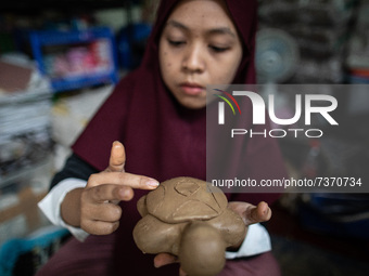 Craftsmen make crafts from cardboard, clay, and wax at the South Tangerang creative craft house, on November 11, 2021 (