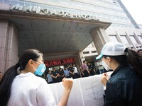 Protesters seen outside the Mayfair hotel where the daily press conference is being held. - Hundreds of residents from near the chemical exp...