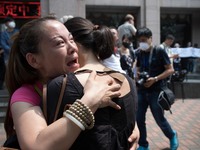 Females protesters comforting each other seen at the protest outside the Mayfair hotel. - Hundreds of residents from near the chemical explo...