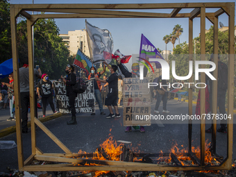 People take part in a demonstration against the government of Sebastian Pinera, in Santiago, Chile, on November 12, 2021. (