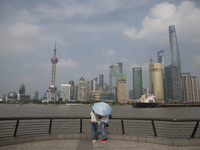 Couple look at the financial distric from the Bund in Shanghai, China, Aug. 17 2015 (