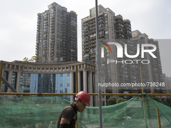 Construction worker walks along a costruction site in Shanghai, China, Aug. 17 2015. (