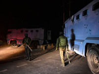 Indian forces stand alert near the encounter site in the Hyderpora area of Srinagar, Indian Administered Kashmir on 15 November 2021. Two su...