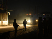 Indian forces stand alert near the encounter site in the Hyderpora area of Srinagar, Indian Administered Kashmir on 15 November 2021. Two su...