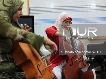 Palestinian young people attend a music class at the Edward Said National Conservatory of Music in Gaza City on Aug. 18, 2015. As the only m...