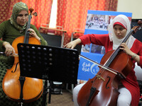 Palestinian young people attend a music class at the Edward Said National Conservatory of Music in Gaza City on Aug. 18, 2015. As the only m...