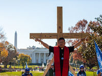 Immigration activist Jose Landaverde hangs on a wooden cross during a direct action by the National TPS Alliance at the White House.  Activi...