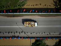 A lorry drives past the Malacca River bridge full of political parties flags at Malacca, Malaysia, on November 19, 2021. Malacca’s state leg...