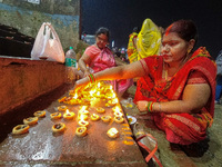 Devotees are seen lighting oil lamps at a Ganges riverside on the occasion of Dev Deepavali in Kolkata , India , on 19 November 2021 .Dev De...
