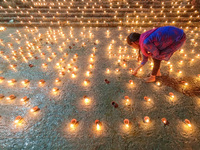 A lady is seen lighting oil lamps on the occasion of Dev Deepavali in Kolkata , India , on 19 November 2021 . Dev Deepavali is a Hindu festi...
