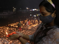 Dev Deepawali festival, Hindu devotee lighting oil lamps The Dev Deepavali festival (litterally the Diwali of the Gods) is celebrated on the...