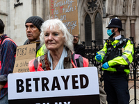 Extinction Rebellion environmental activists protest in from of the Royal Courts of Justice in support of Insulate Britain protesters who we...