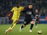 Leo Messi of and  n42 compete for the ball during the Ligue 1 Uber Eats match between Paris Saint Germain and FC Nantes at Parc des Princes...
