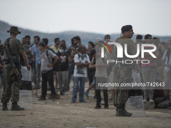 Police officers guard the migrants  on the Macedonian-Greek border near the town of Gevgelija, on August 20, 2015.
Macedonia declared emerge...